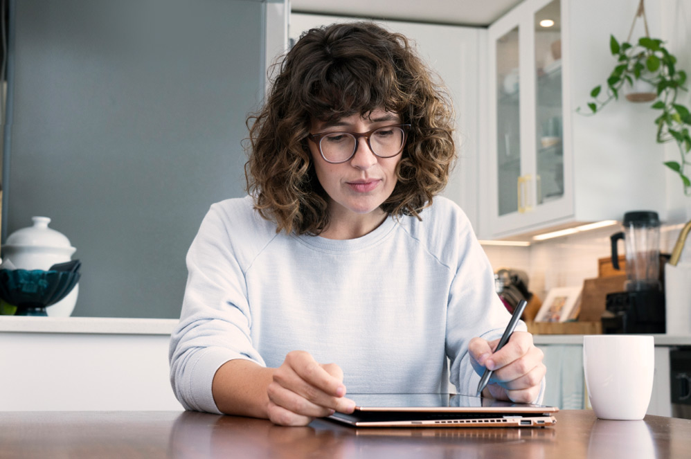 Woman draws with a digital pen on a tablet computer