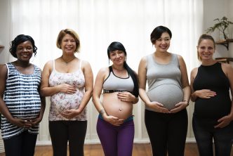 Multiple pregnant women posing